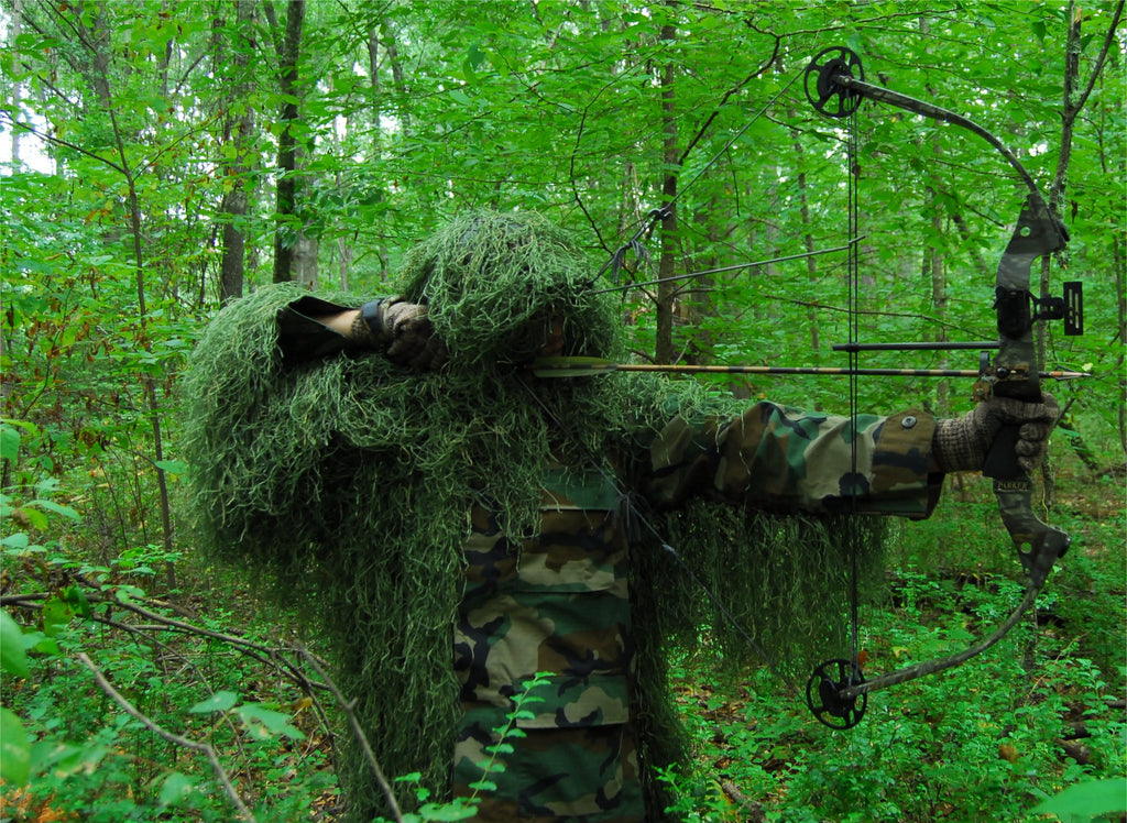 Ultra Light Ghillie Bow Hunting Jacket in Leafy Green, shown with bow