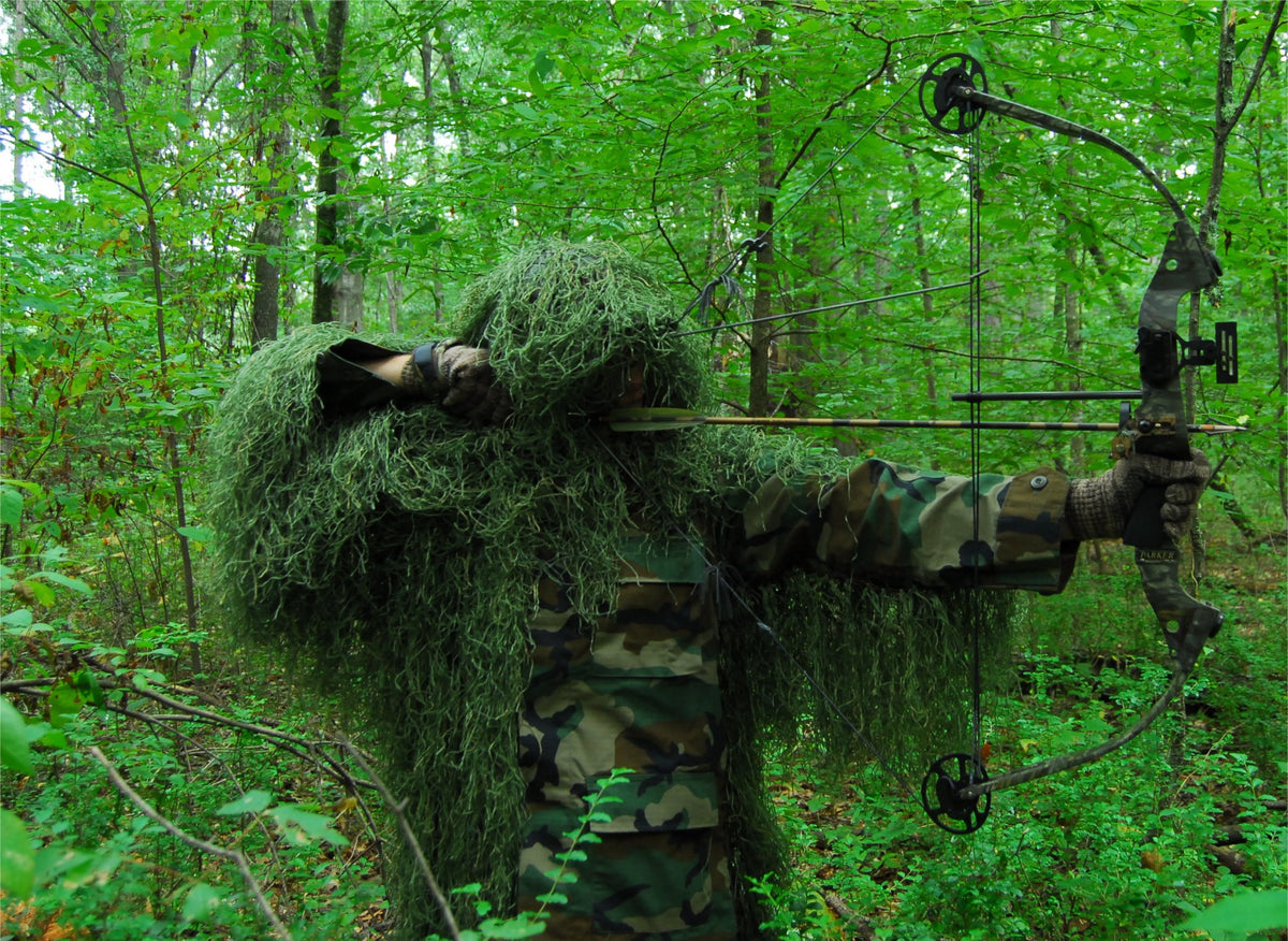 Ultra Light Ghillie Bow Hunting Jacket in Leafy Green, shown with bow