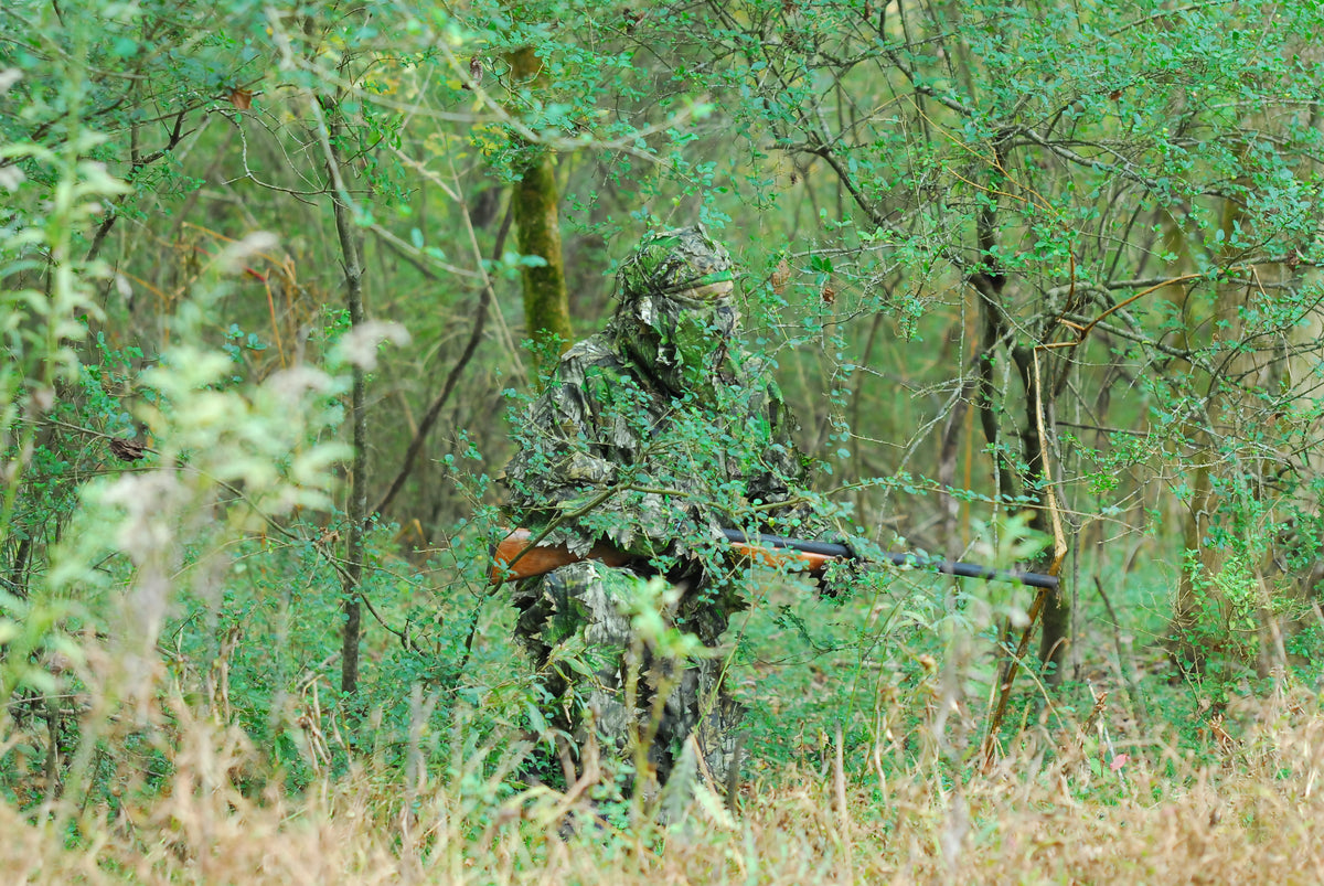 Hunter wearing a Titan 3D Mossy Oak Obsession leafy suit while turkey hunting