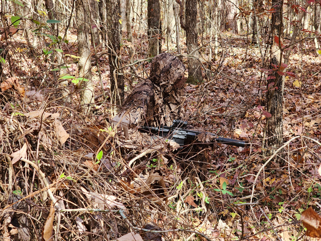 Hunter wearing a Titan 3D Realtree Timber leafy suit in the woods